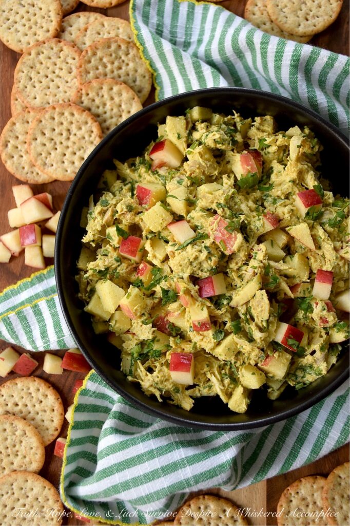 Mild Curry Chicken Salad with Diced Red Apples - This mild curry chicken salad features tender shredded rotisserie chicken tossed in a creamy, golden dressing that brings all the aromatic warmth of curry without the fiery heat. Paired with the sweet, crunchy snap of diced red apples, it's a light, flavorful chicken salad perfect for serving on crispy wheat crackers or for making sandwiches. Whether you stir in a handful of fresh cilantro for an herbal pop of bright color or opt for scallions, parsley, celery, or onion instead, this chicken salad is sure to be an instant favorite.