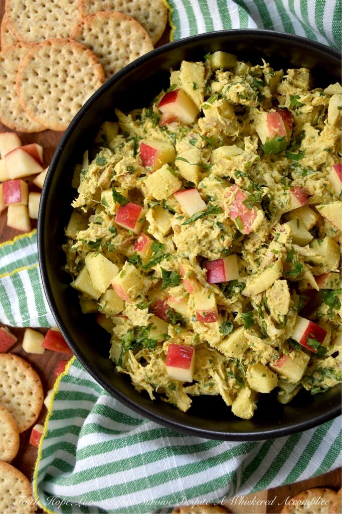 Mild Curry Chicken Salad with Diced Red Apples - This mild curry chicken salad features tender shredded rotisserie chicken tossed in a creamy, golden dressing that brings all the aromatic warmth of curry without the fiery heat. Paired with the sweet, crunchy snap of diced red apples, it's a light, flavorful chicken salad perfect for serving on crispy wheat crackers or for making sandwiches. Whether you stir in a handful of fresh cilantro for an herbal pop of bright color or opt for scallions, parsley, celery, or onion instead, this chicken salad is sure to be an instant favorite.