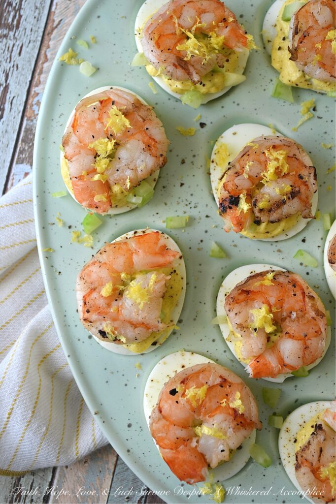 Buttery Deviled Eggs with Celery & Shrimp - The secret to the world’s creamiest deviled eggs isn’t more mayo, but a little bit of softened butter. It sounds simple, but this small addition instantly transforms a classic deviled egg into a sophisticated appetizer with a luxurious filling that pairs perfectly with the zing of fresh lemon and the satisfying crunch of celery. Balanced with a spicy kick of black pepper and crowned with a tender piece of steamed or grilled shrimp, these eggs are an elegant small bite sure to impress.