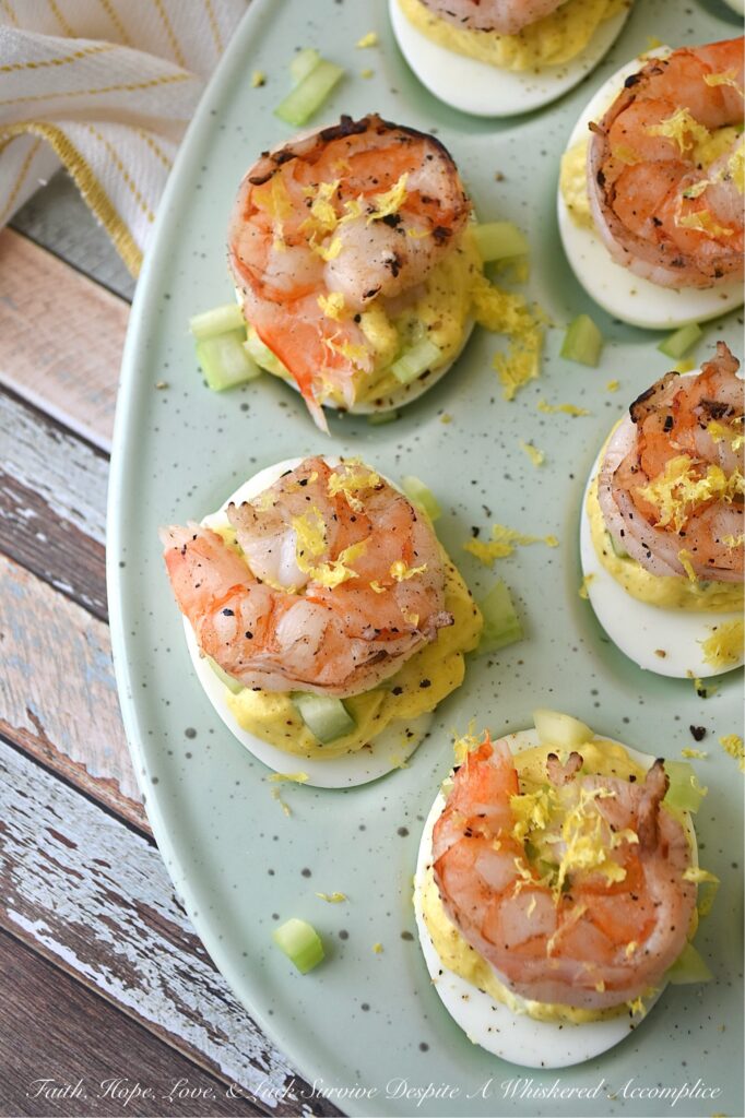 Buttery Deviled Eggs with Celery & Shrimp - The secret to the world’s creamiest deviled eggs isn’t more mayo, but a little bit of softened butter. It sounds simple, but this small addition instantly transforms a classic deviled egg into a sophisticated appetizer with a luxurious filling that pairs perfectly with the zing of fresh lemon and the satisfying crunch of celery. Balanced with a spicy kick of black pepper and crowned with a tender piece of steamed or grilled shrimp, these eggs are an elegant small bite sure to impress.