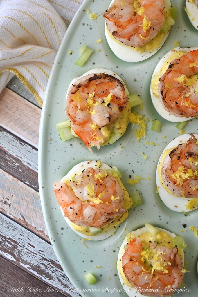 Buttery Deviled Eggs with Celery & Shrimp - The secret to the world’s creamiest deviled eggs isn’t more mayo, but a little bit of softened butter. It sounds simple, but this small addition instantly transforms a classic deviled egg into a sophisticated appetizer with a luxurious filling that pairs perfectly with the zing of fresh lemon and the satisfying crunch of celery. Balanced with a spicy kick of black pepper and crowned with a tender piece of steamed or grilled shrimp, these eggs are an elegant small bite sure to impress.