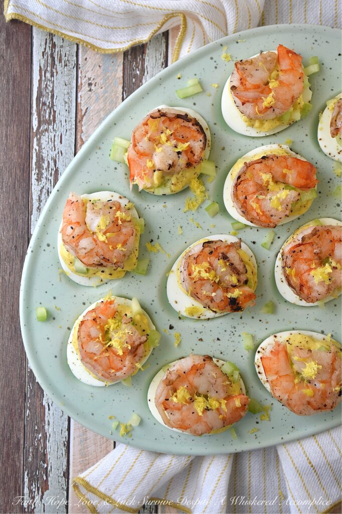 Buttery Deviled Eggs with Celery & Shrimp - The secret to the world’s creamiest deviled eggs isn’t more mayo, but a little bit of softened butter. It sounds simple, but this small addition instantly transforms a classic deviled egg into a sophisticated appetizer with a luxurious filling that pairs perfectly with the zing of fresh lemon and the satisfying crunch of celery. Balanced with a spicy kick of black pepper and crowned with a tender piece of steamed or grilled shrimp, these eggs are an elegant small bite sure to impress.