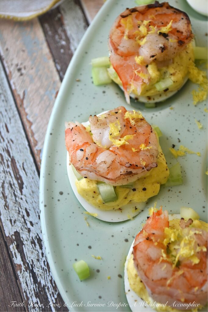 Buttery Deviled Eggs with Celery & Shrimp - The secret to the world’s creamiest deviled eggs isn’t more mayo, but a little bit of softened butter. It sounds simple, but this small addition instantly transforms a classic deviled egg into a sophisticated appetizer with a luxurious filling that pairs perfectly with the zing of fresh lemon and the satisfying crunch of celery. Balanced with a spicy kick of black pepper and crowned with a tender piece of steamed or grilled shrimp, these eggs are an elegant small bite sure to impress.
