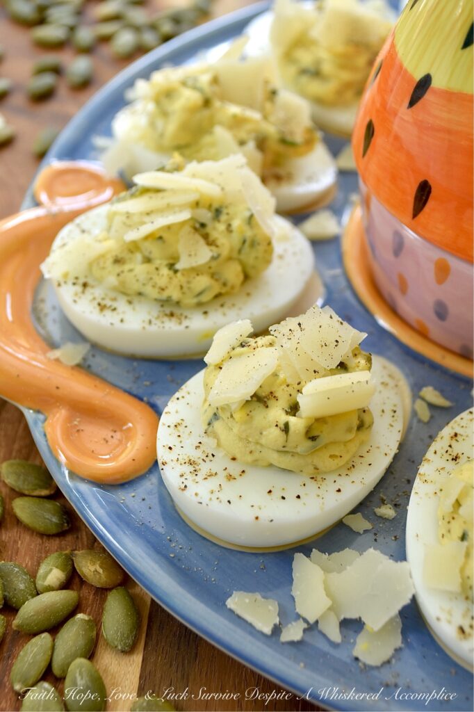 Deviled Eggs with Basil Pumpkin Seed Pesto - Imagine a deviled egg filling that is impossibly creamy, brightened up with a burst of fresh basil and lemon, and finished with the satisfying, earthy crunch of roasted salted pepitas. It’s a texture lover’s dream. Topped with a sprinkle of finely ground black pepper and crumbled shaved Parmesan cheese, this deviled egg recipe strikes the perfect balance of creamy, salty, nutty, tangy flavor. Sophisticated enough for a holiday appetizer but simple enough for a Tuesday night craving, these Deviled Eggs with Basil Pumpkin Seed Pesto are the year-round staple your recipe box has been missing.