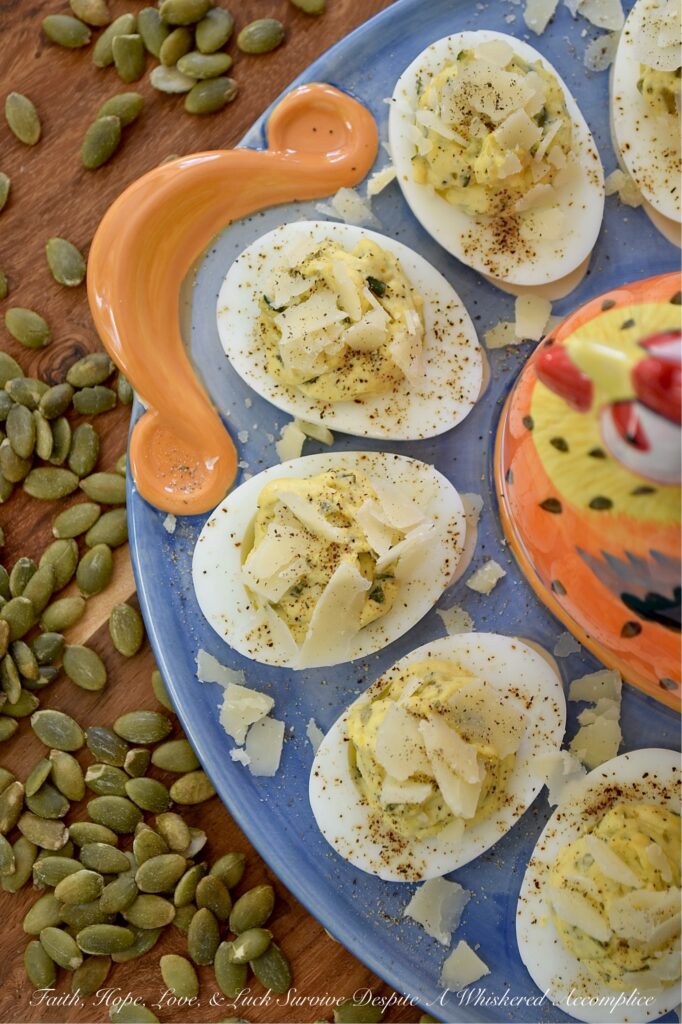 Deviled Eggs with Basil Pumpkin Seed Pesto - Imagine a deviled egg filling that is impossibly creamy, brightened up with a burst of fresh basil and lemon, and finished with the satisfying, earthy crunch of roasted salted pepitas. It’s a texture lover’s dream. Topped with a sprinkle of finely ground black pepper and crumbled shaved Parmesan cheese, this deviled egg recipe strikes the perfect balance of creamy, salty, nutty, tangy flavor. Sophisticated enough for a holiday appetizer but simple enough for a Tuesday night craving, these Deviled Eggs with Basil Pumpkin Seed Pesto are the year-round staple your recipe box has been missing.