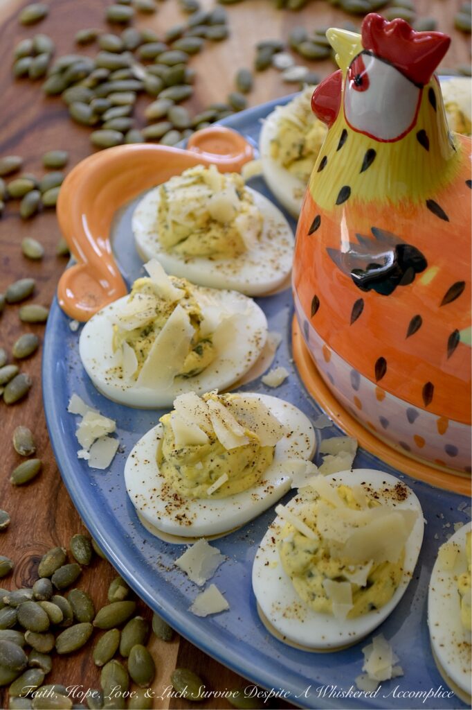 Deviled Eggs with Basil Pumpkin Seed Pesto - Imagine a deviled egg filling that is impossibly creamy, brightened up with a burst of fresh basil and lemon, and finished with the satisfying, earthy crunch of roasted salted pepitas. It’s a texture lover’s dream. Topped with a sprinkle of finely ground black pepper and crumbled shaved Parmesan cheese, this deviled egg recipe strikes the perfect balance of creamy, salty, nutty, tangy flavor. Sophisticated enough for a holiday appetizer but simple enough for a Tuesday night craving, these Deviled Eggs with Basil Pumpkin Seed Pesto are the year-round staple your recipe box has been missing.