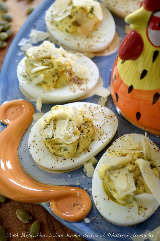 Deviled Eggs with Basil Pumpkin Seed Pesto - Imagine a deviled egg filling that is impossibly creamy, brightened up with a burst of fresh basil and lemon, and finished with the satisfying, earthy crunch of roasted salted pepitas. It’s a texture lover’s dream. Topped with a sprinkle of finely ground black pepper and crumbled shaved Parmesan cheese, this deviled egg recipe strikes the perfect balance of creamy, salty, nutty, tangy flavor. Sophisticated enough for a holiday appetizer but simple enough for a Tuesday night craving, these Deviled Eggs with Basil Pumpkin Seed Pesto are the year-round staple your recipe box has been missing.