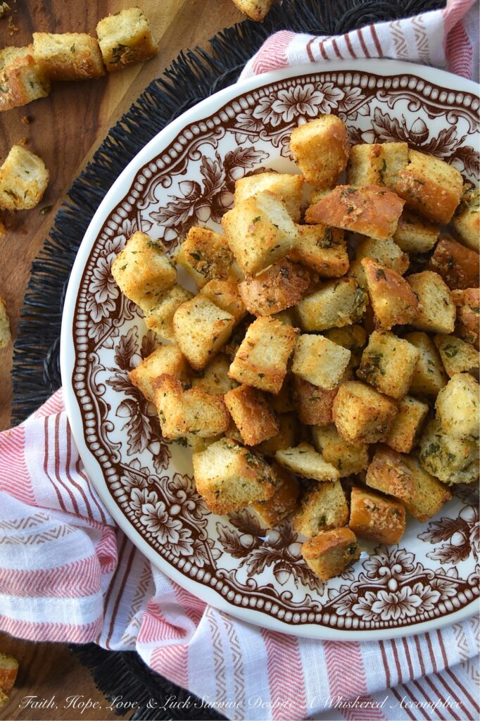 Simple Baked Olive Oil Croutons with Parmesan - Forget tossing out rock-hard baguettes or leftover dinner rolls. With a generous drizzle of olive oil, a few everyday savory seasonings, and a generous sprinkle of nutty, salty Parmesan cheese, you can easily transform yesterday's stale bread into golden, crispy, flavor-packed croutons in minutes. Whether you’re tossing these simple baked croutons into a crisp salad or drowning them in a cozy bowl of soup, these homemade gems are so irresistibly crunchy, you'll find yourself intentionally letting bread go stale just to make them.
