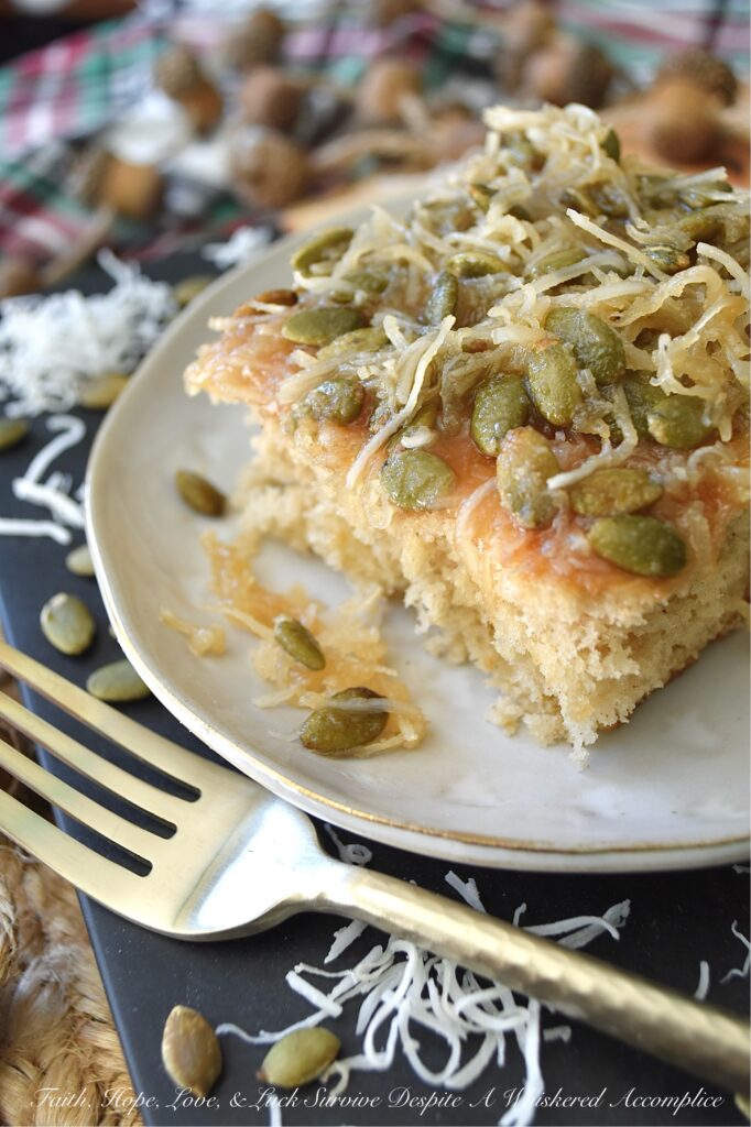 Fall Pear Ugly Duckling Cake (Cake Mix Recipe) - Don’t let the quirky name fool you. This simple, fall-inspired rustic “ugly duckling cake” bakes up into a sweet, buttery, incredibly moist, unforgettable cake. Infused with cozy fall flavors like pear and warm cinnamon, plus a delightful crunch from unsweetened shredded coconut and roasted salted pepitas or pumpkin seeds, this amped-up cake mix recipe is about to become your new favorite autumn obsession. Who knew a can of pears and a box of store-bought cake mix could become something almost magical?
