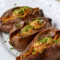 Crockpot Cajun Butter Roasted Sweet Potatoes - Looking for an easy summer BBQ side dish or a low-effort comforting winter Meatless Monday recipe? Look no further than these sweet crockpot roasted sweet potatoes topped with Cajun butter. These slow-cooked sweet potatoes could just easily become your new favorite way to eat sweet potatoes.