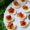 Southern Red Pepper Jelly Deviled Eggs - If you're looking for a holiday appetizer that your guests will swoon over, this is it. The combination of red pepper jelly, cream cheese, and bacon in these deviled eggs will certainly leave a winning impression. And honestly, we wouldn’t blame you one bit if you decided not to wait for a special holiday to whip up a batch.