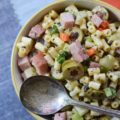 Muffuletta Pasta Salad - This amazingly flavorful muffuletta pasta salad has all of the good stuff in it, including ham, genoa salami, provolone cheese, celery, carrots, scallions, and lots and lots of green olives. It's definitely anything but bland, and I'm willing to bet that it may just become your new go-to pasta salad recipe.