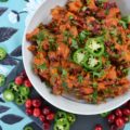 Warm Cranberry & Jalapeño Sweet Potato Salad - This warm side salad is made using oven-roasted sweet potatoes and cranberries, which are tossed in a sweet and spicy sauce, along with chopped scallions, finely diced jalapeño, and fresh parsley. This unique and flavorful summer potato salad just goes to show you that sweet potatoes and cranberries aren't just for Thanksgiving anymore.