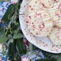 White Christmas Peppermint Holiday Cookies - Not only do these peppermint holiday cookies practically melt in your mouth, but due to their flaky texture, they almost crumble apart at the gentlest touch. Thankfully the white chocolate they are drizzled with helps keep them together just long enough for you to get them from your hand to your mouth. Sure there may be a few crumbs dropped during the process, but who can't live with a few crumbs at Christmas time?