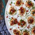 Sweet Chili & Honey Pimento Deviled Eggs - If you're searching for a deviled egg recipe that is just as flavorful as it is gorgeous, look no further. These pimento and chive-topped deviled eggs are stunning, yet packed with flavor as well. Sweet honey, chili powder, flaky sea salt, black pepper, mayonnaise, and a little touch of balsamic vinegar, combined with a jar of diced pimentos and freshly chopped chives, is all that it takes to make an appetizer that absolutely no one will be able to resist.