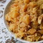 Autumn Crockpot Apple Sauerkraut - Give your crockpot sauerkraut the taste of autumn with the addition of seasonal apples, brown sugar, Oktoberfest beer, diced onion, and caraway seeds.