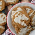 Iced Eggnog Chewy Spice Cookies - These delicious holiday cookies are spiced with ginger, cinnamon, nutmeg, and cloves for a festive flavor. To make them even better, they are topped with a delicious eggnog powdered sugar icing. With the combination of spices and sweet eggnog icing, these iced eggnog chewy spice cookies are sure to please.