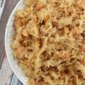 Dried Apple & Bourbon Oven-Baked Sauerkraut - This Dried Apple & Bourbon Oven-Baked Sauerkraut is a simple yet delicious side dish that combines the tanginess of sauerkraut with the sweetness of dried apples and brown sugar plus the bold and smoky flavor of bourbon. It's the perfect side dish to add some variety to your meals and is sure to be a crowd-pleaser for any game day, cookout, or holiday gathering. If you're looking for a new way to enjoy sauerkraut, be prepared to be blown away by this delicious sweet and tangy version.