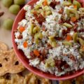 Italian Mozzarella & Green Olive Cheese Spread - If you’re looking for a cheese spread that’s ready to party, this Italian-inspired mozzarella cheese spread is it. Loaded with salty pimento-stuffed green olives, sweet sun-dried tomatoes, and a good sprinkle of Italian herbs, this is the kind of cheesy goodness that’s just as happy piled onto pretzels, crackers, or pita crisps as it is tucked inside a mini sandwich. And, with its cheery pop of red and green, this appetizer is basically waving its arms and shouting, "Pick me!" for your holiday snack table.