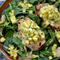 Caribbean Pineapple & Honey Mustard Pork Chops - While most of us aren’t lucky enough to be lounging on a beach in the Caribbean, we can certainly bring the spirit of the islands straight to our dinner table with these sweet and spicy grilled pork chops. The secret is an easy-to-make homemade jerk seasoning blend used to season both sides of each pork chop before grilling. That same seasoning mix is also used to make a simple honey mustard sauce and a quick pineapple sweet yellow onion salsa, both of which top each seared pork chop. Served over a crisp bed of baby spinach, this is the ultimate summer meal. Light, refreshing, and guaranteed to make your summer dinner feel like a getaway.