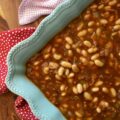 Smoky Baked Beans with Green Chiles & Bacon - Most store-bought baked beans are overly sweet, mushy, and entirely forgettable. This recipe, however, uses canned Great Northern Beans. Elevating them with a quick and easy homemade sauce. Between the smoky bacon, the subtle heat of green chiles, and the deep, wood-fired flavor from a generous splash of liquid smoke, these beans are practically addictive. They're thick, sticky, smoky, and best of all? You can prep them days in advance, making this side dish the perfect stress-free secret weapon for your next backyard barbecue or picnic.