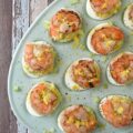 Buttery Deviled Eggs with Celery & Shrimp - The secret to the world’s creamiest deviled eggs isn’t more mayo, but a little bit of softened butter. It sounds simple, but this small addition instantly transforms a classic deviled egg into a sophisticated appetizer with a luxurious filling that pairs perfectly with the zing of fresh lemon and the satisfying crunch of celery. Balanced with a spicy kick of black pepper and crowned with a tender piece of steamed or grilled shrimp, these eggs are an elegant small bite sure to impress.