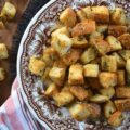 Simple Baked Olive Oil Croutons with Parmesan - Forget tossing out rock-hard baguettes or leftover dinner rolls. With a generous drizzle of olive oil, a few everyday savory seasonings, and a generous sprinkle of nutty, salty Parmesan cheese, you can easily transform yesterday's stale bread into golden, crispy, flavor-packed croutons in minutes. Whether you’re tossing these simple baked croutons into a crisp salad or drowning them in a cozy bowl of soup, these homemade gems are so irresistibly crunchy, you'll find yourself intentionally letting bread go stale just to make them.